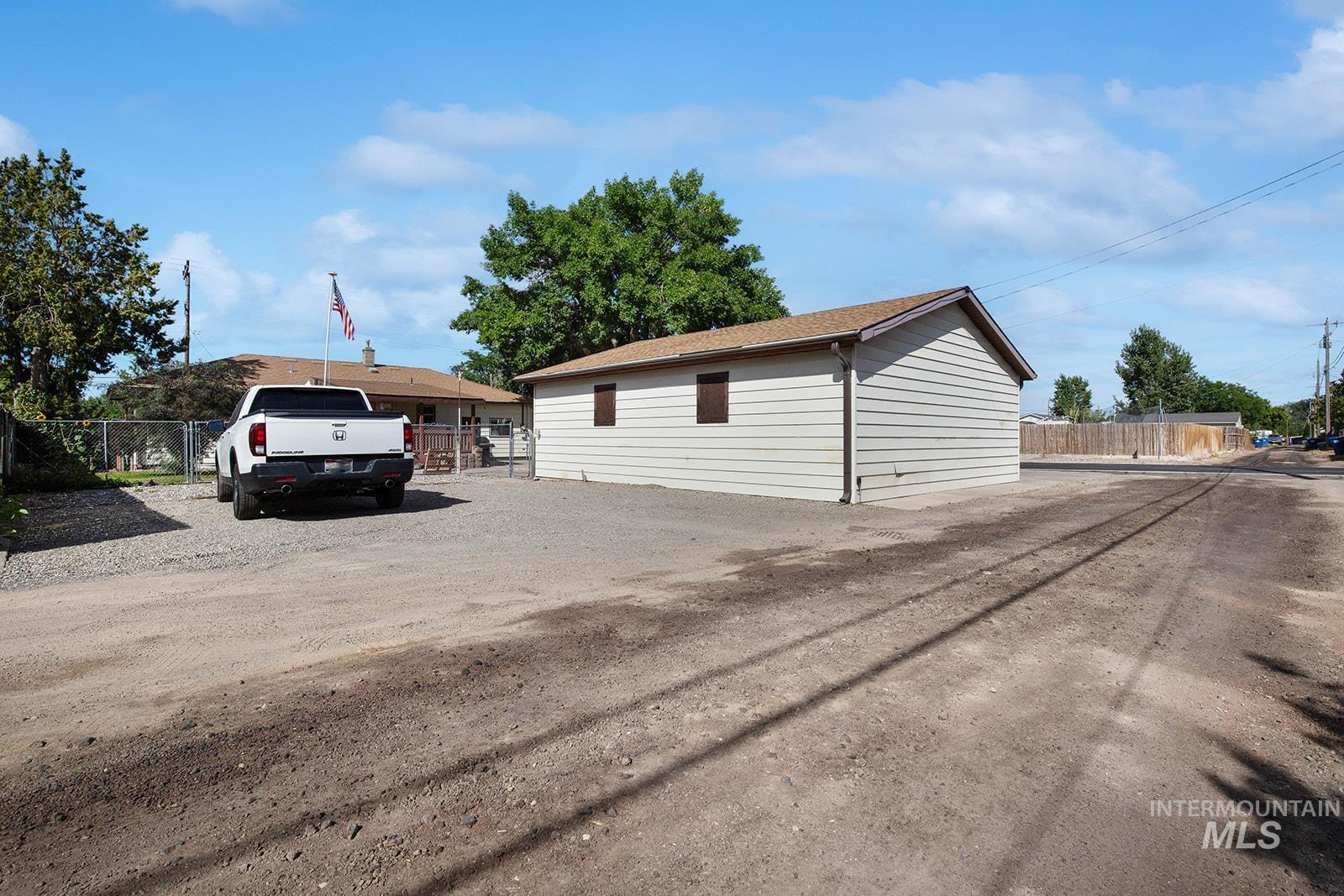 View of side of property with dirt driveway