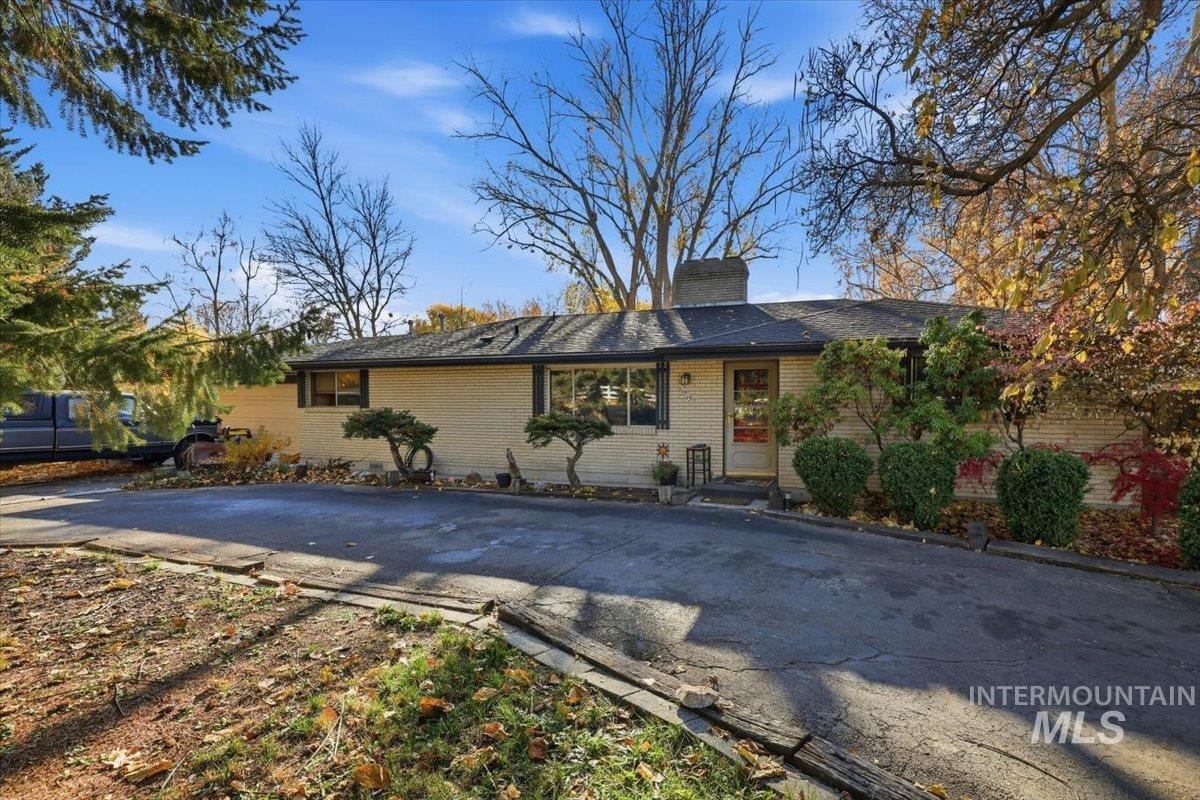 View of front of house with brick siding and a chimney