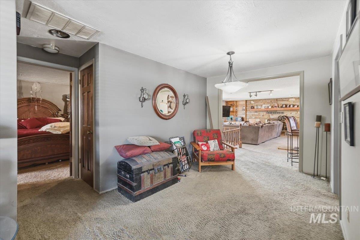 Sitting room featuring carpet flooring, track lighting, and a textured ceiling