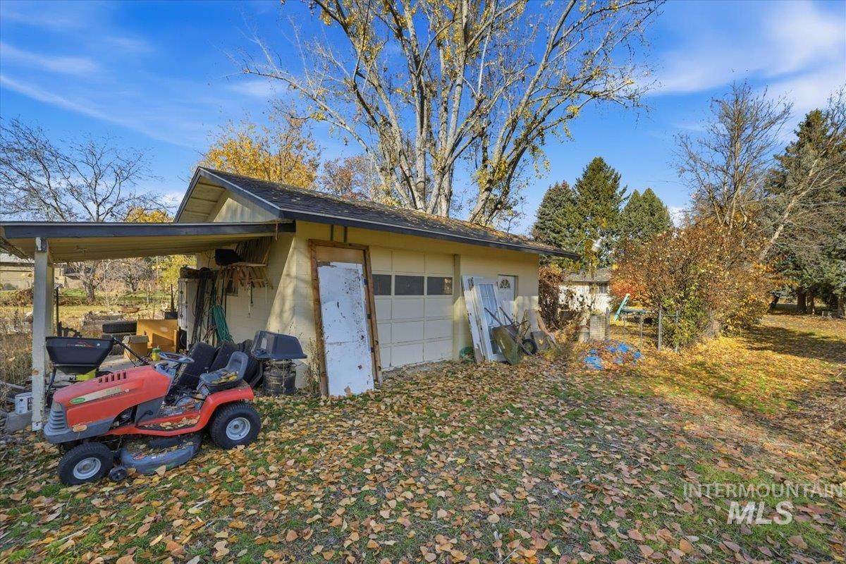 View of side of home featuring an outbuilding and concrete block siding
