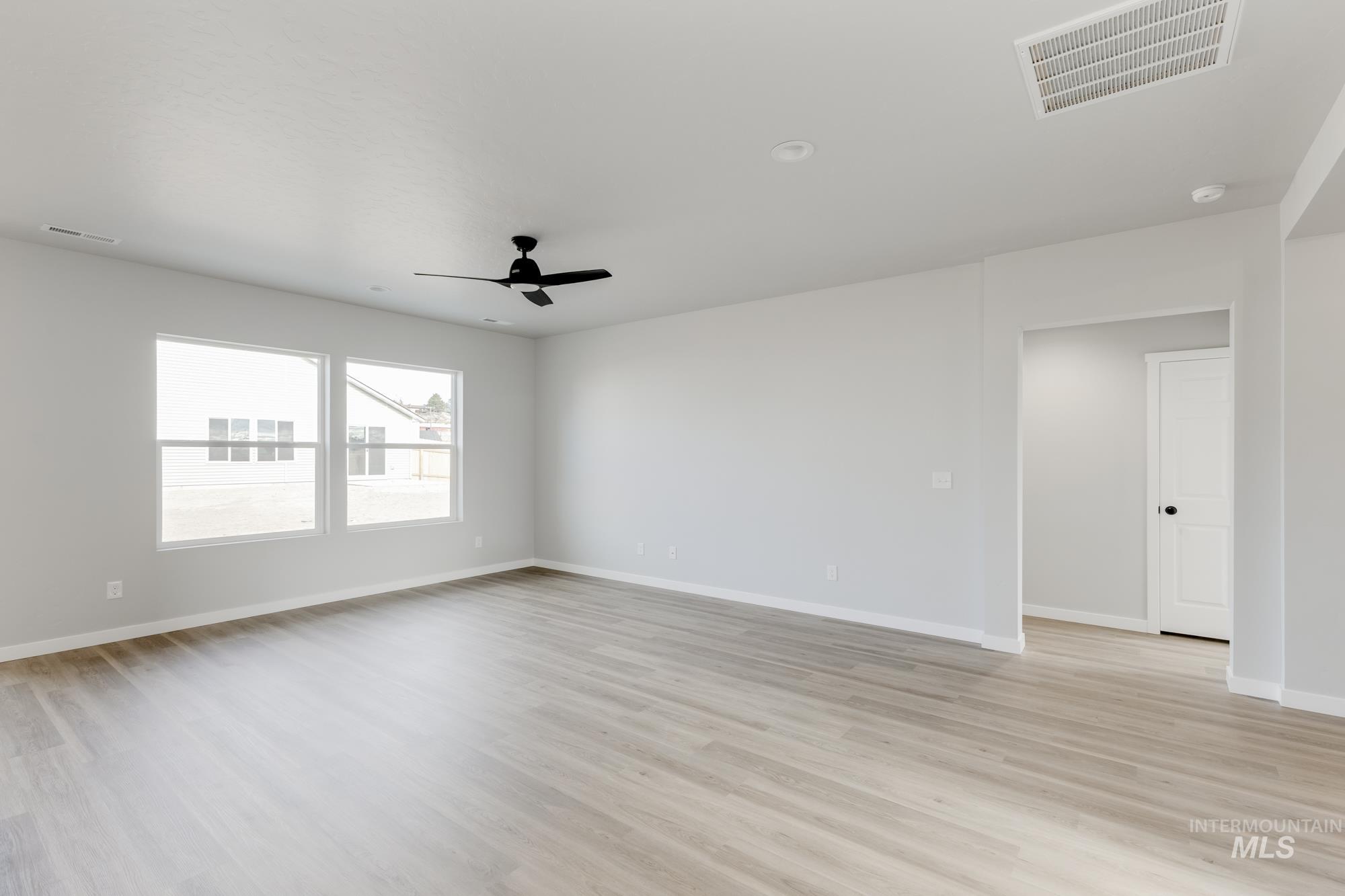 Spare room featuring a ceiling fan and light wood finished floors
