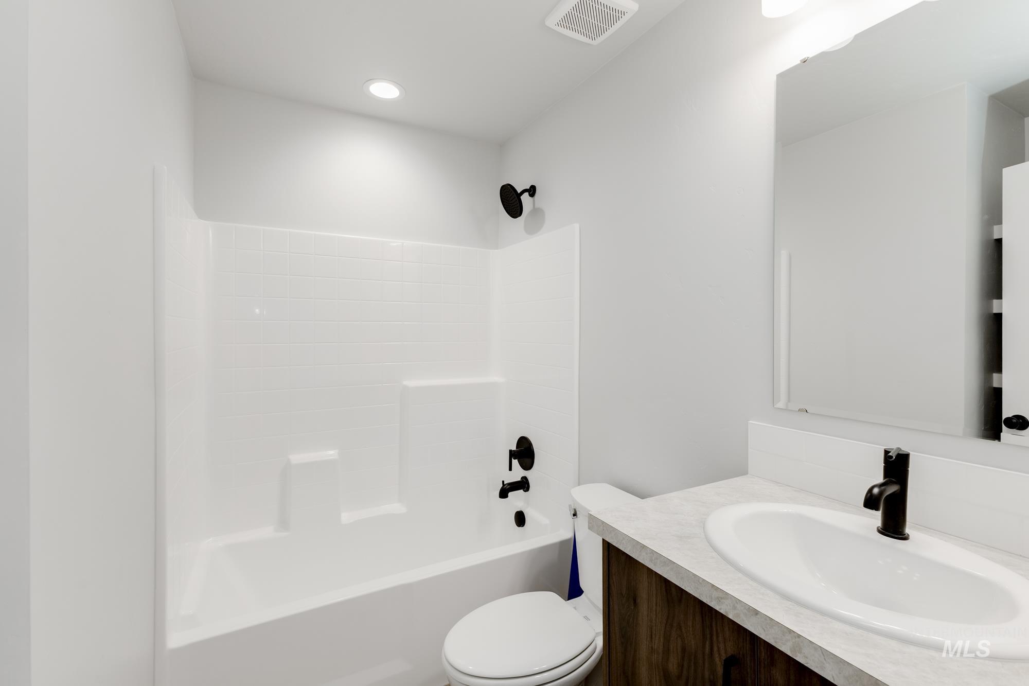Bathroom featuring vanity and shower / bath combination