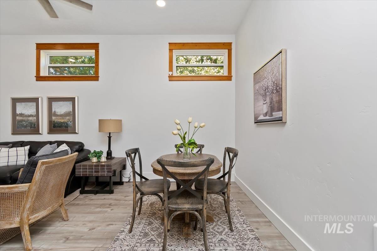 Dining space with light wood-style floors and recessed lighting