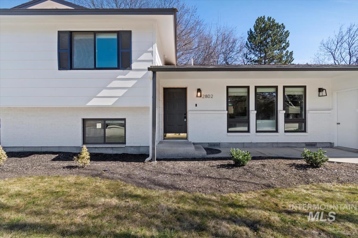 View of front of home with a front lawn and brick siding