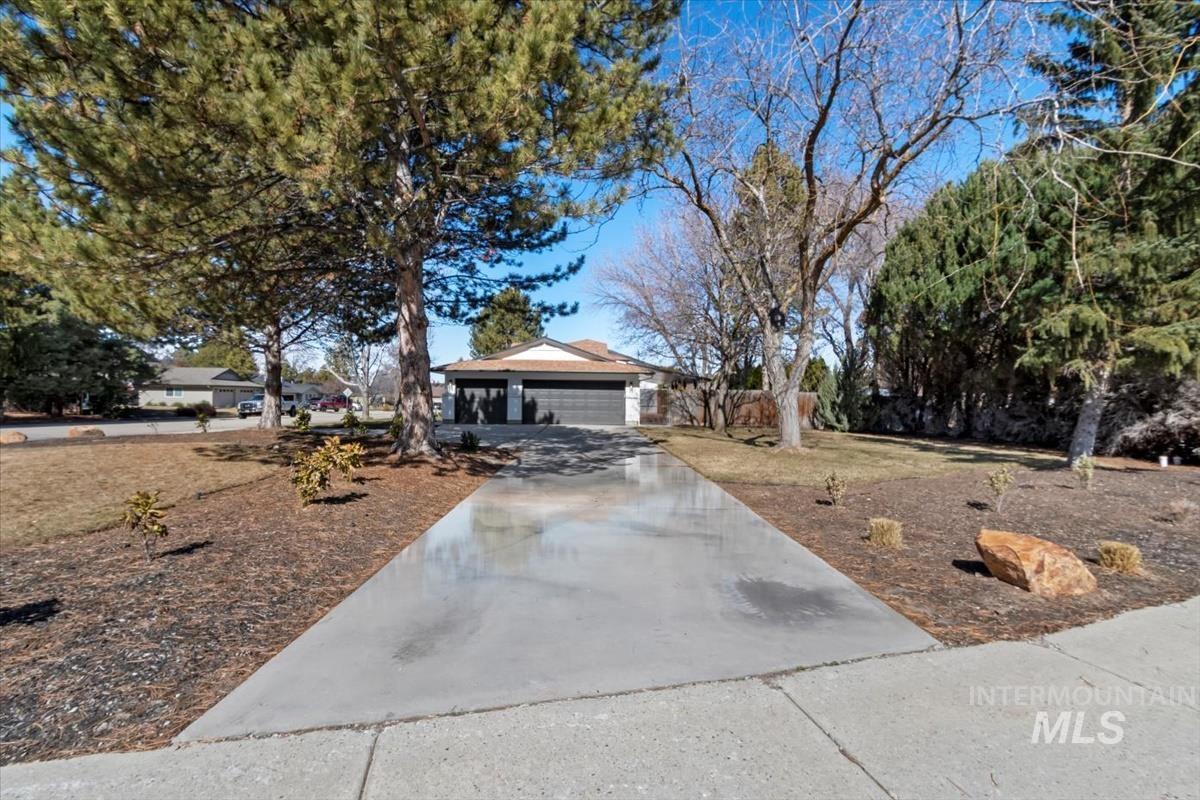 View of front of property with driveway and a garage