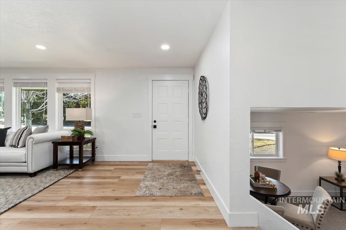 Foyer with plenty of natural light, light wood-type flooring, and recessed lighting