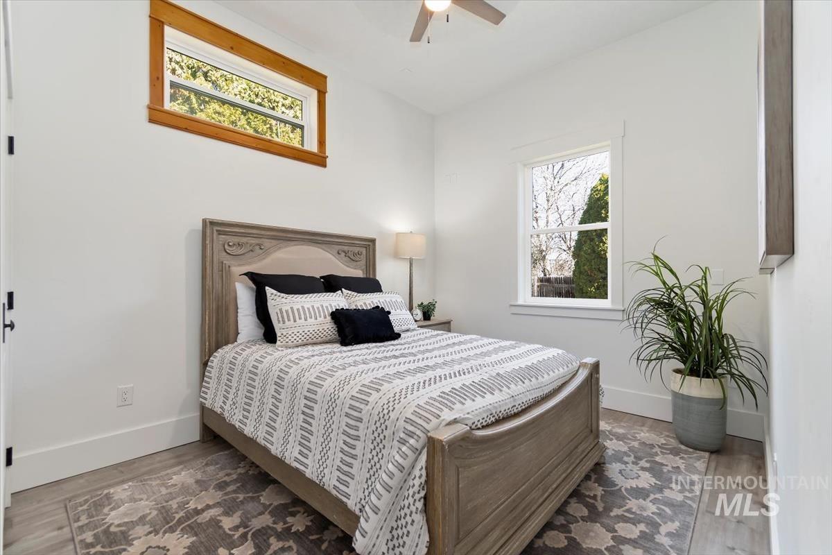 Bedroom with wood finished floors and ceiling fan