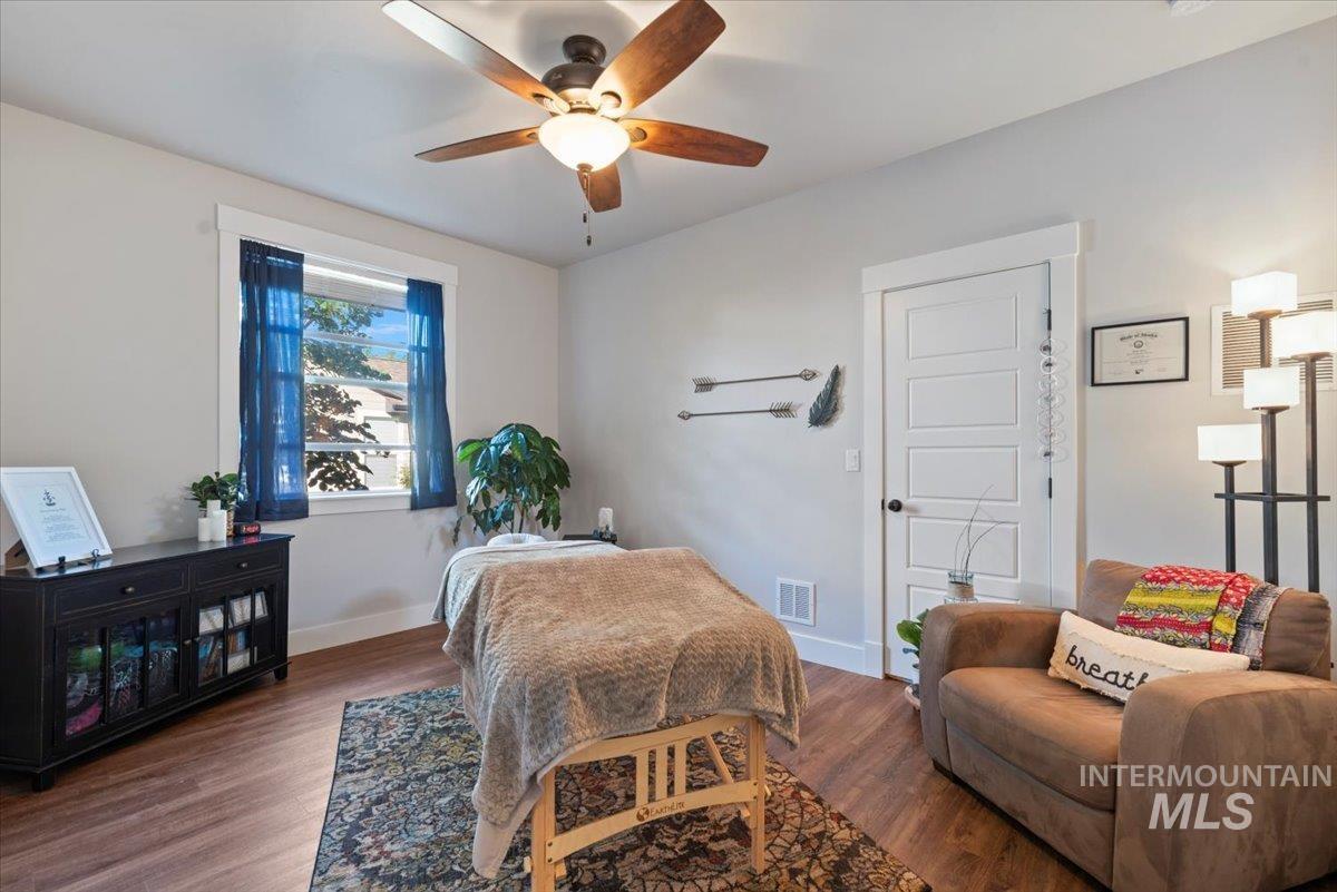 Bedroom featuring wood finished floors and ceiling fan
