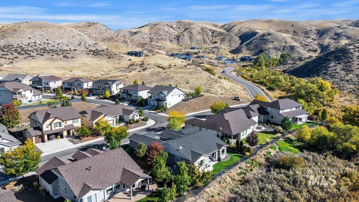Aerial view of property and surrounding area with mountains