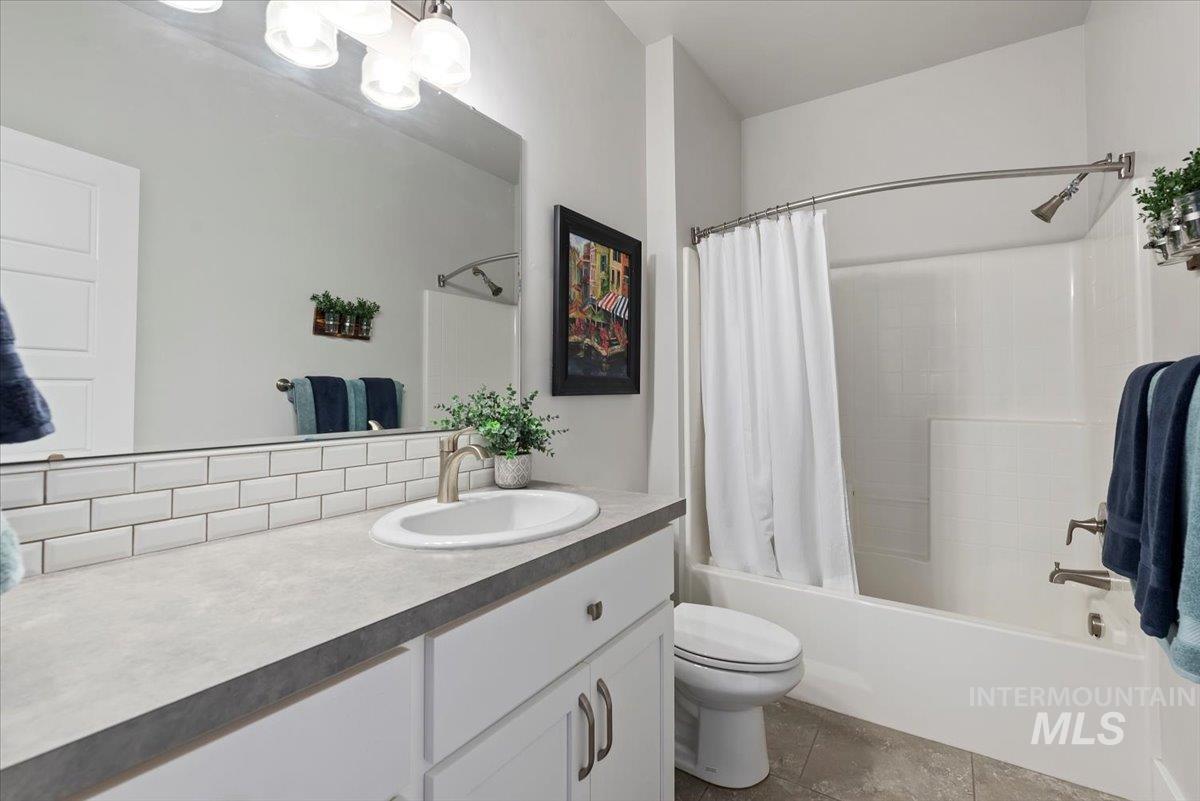 Full bath featuring shower / tub combo and vanity