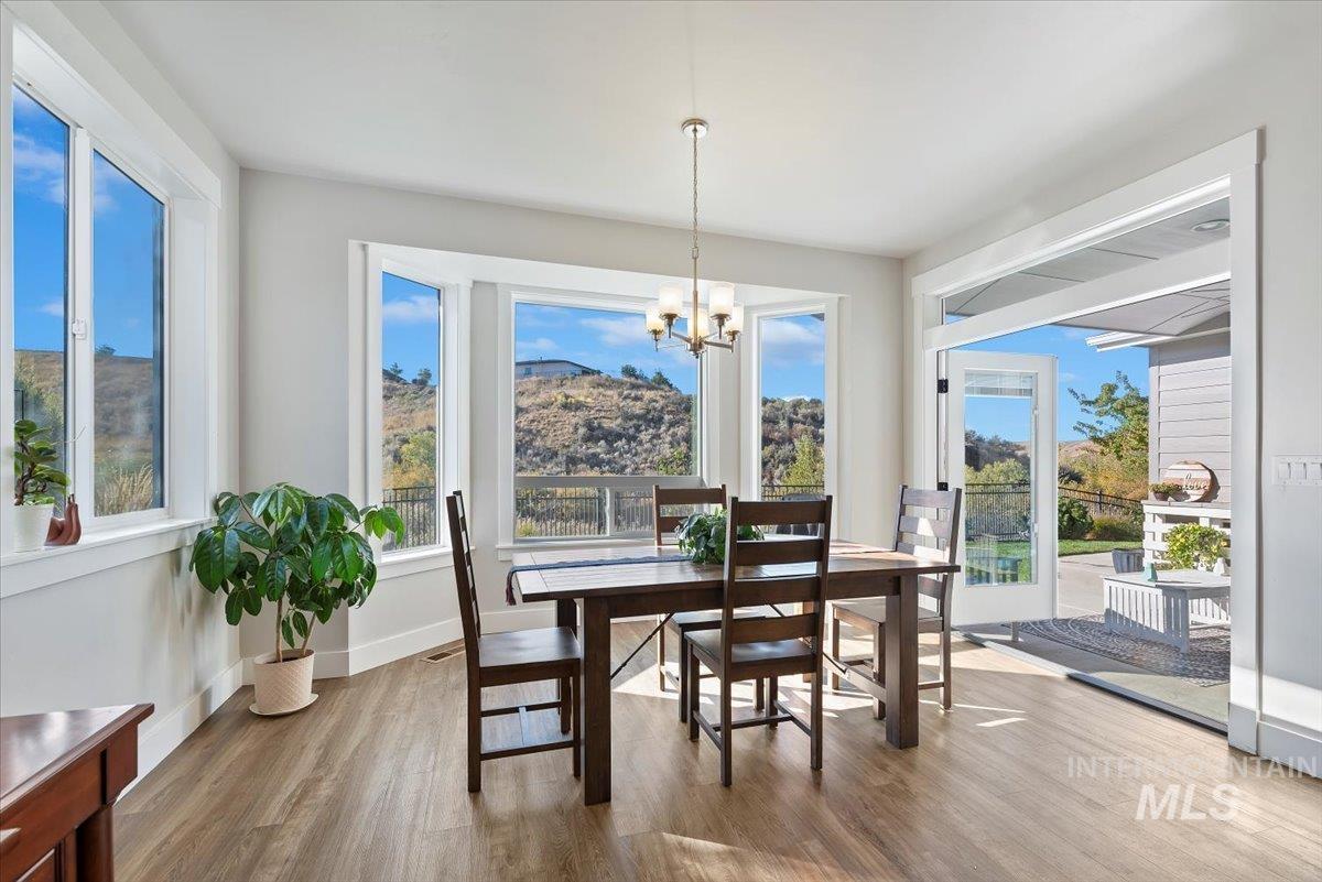 Dining area featuring light wood-style flooring and a chandelier