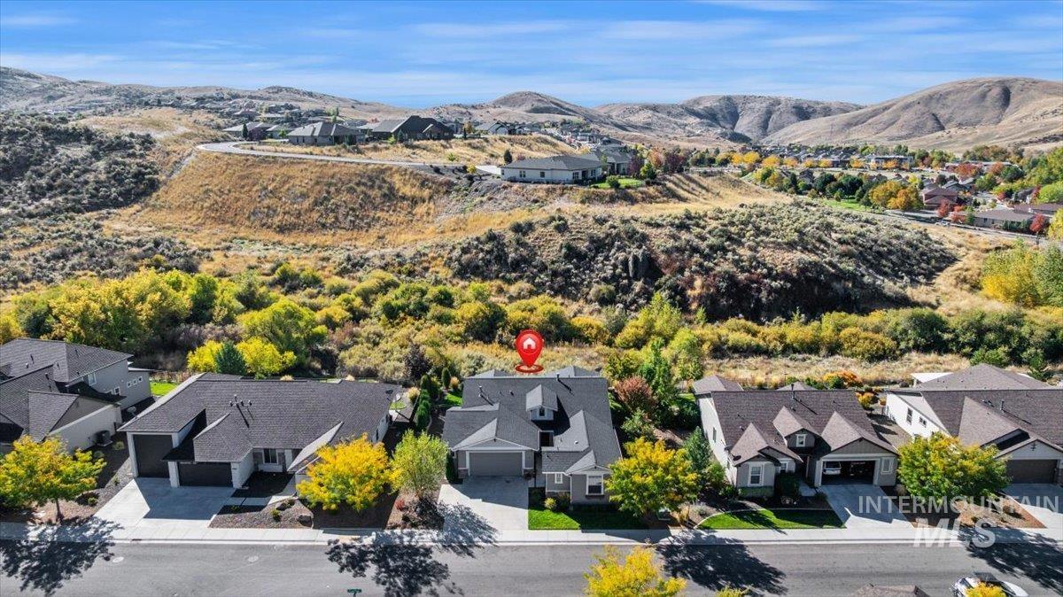 Aerial perspective of suburban area featuring a mountainous background