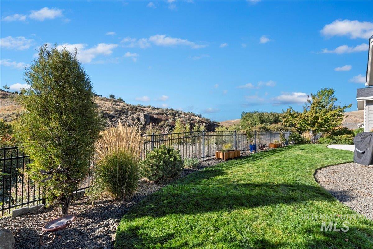 Fenced backyard featuring a mountain view