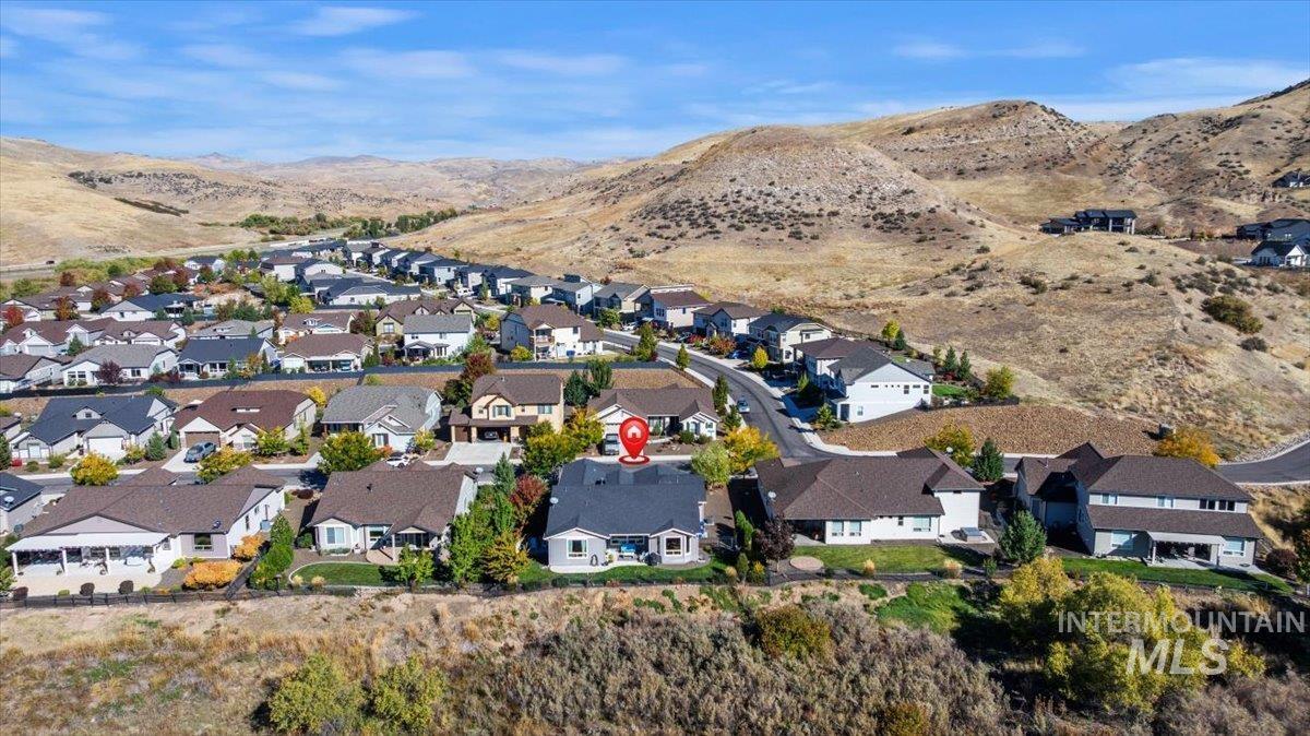 Aerial overview of property's location featuring mountains and nearby suburban area