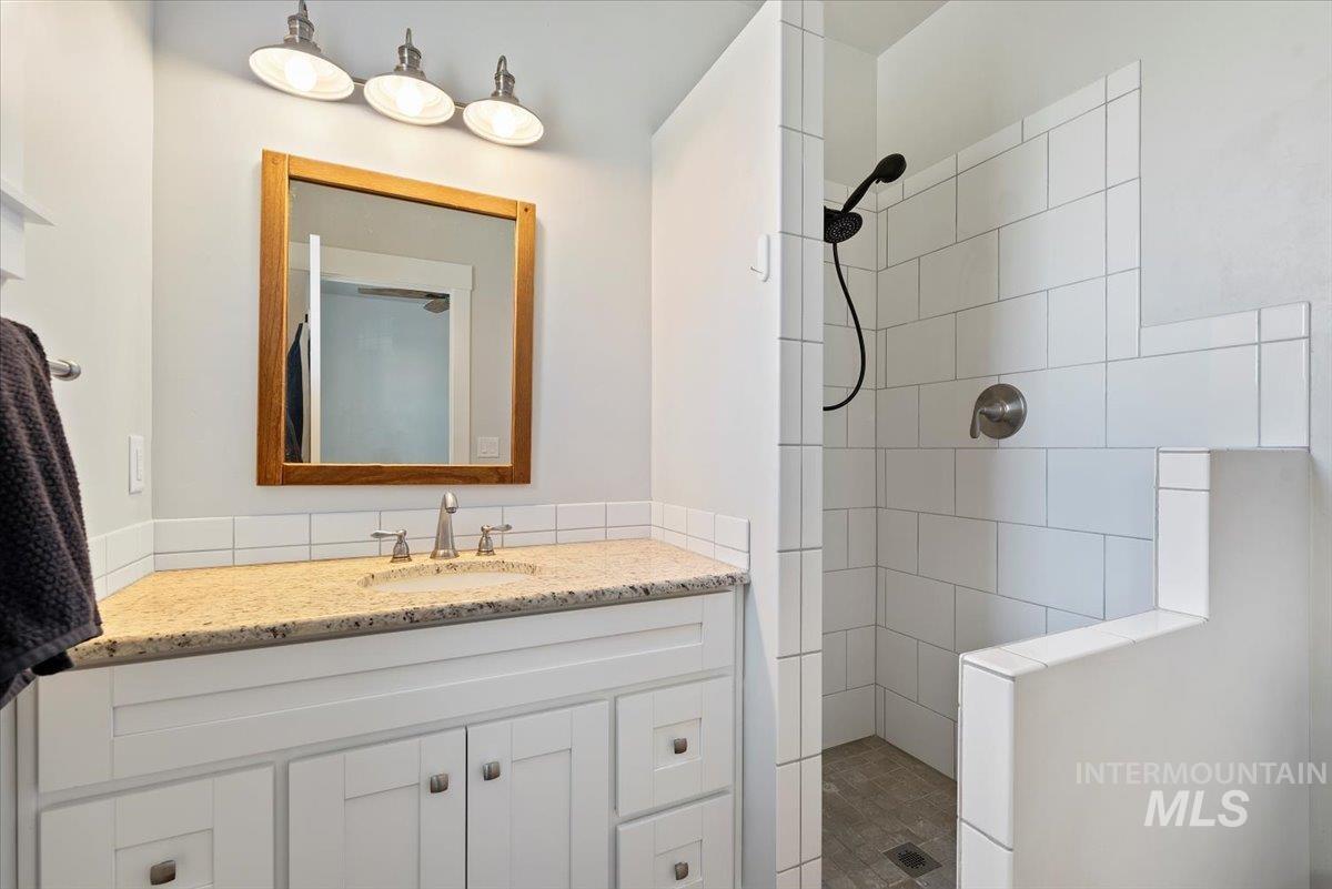 Bathroom featuring walk in shower and vanity