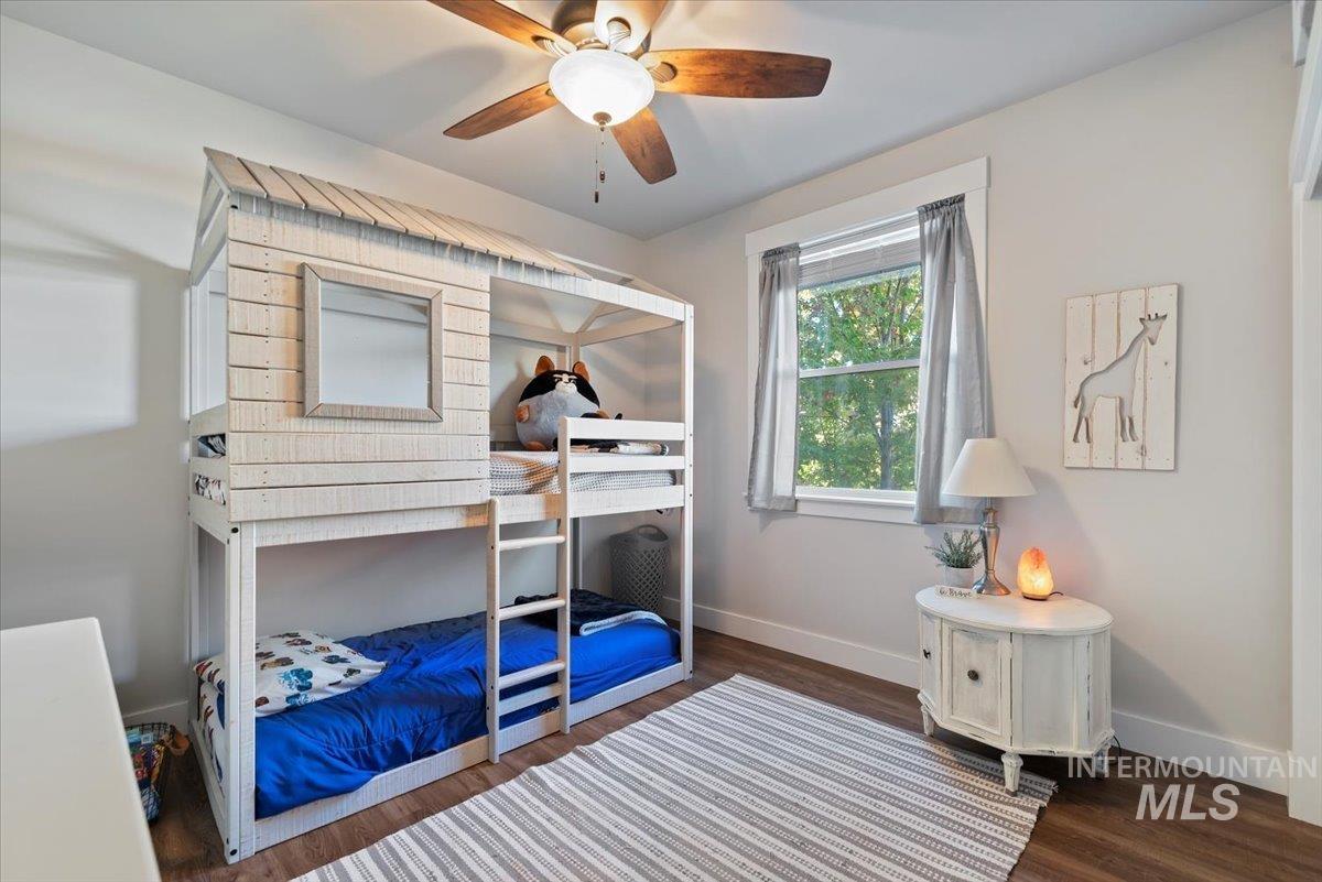 Bedroom featuring dark wood-type flooring and ceiling fan