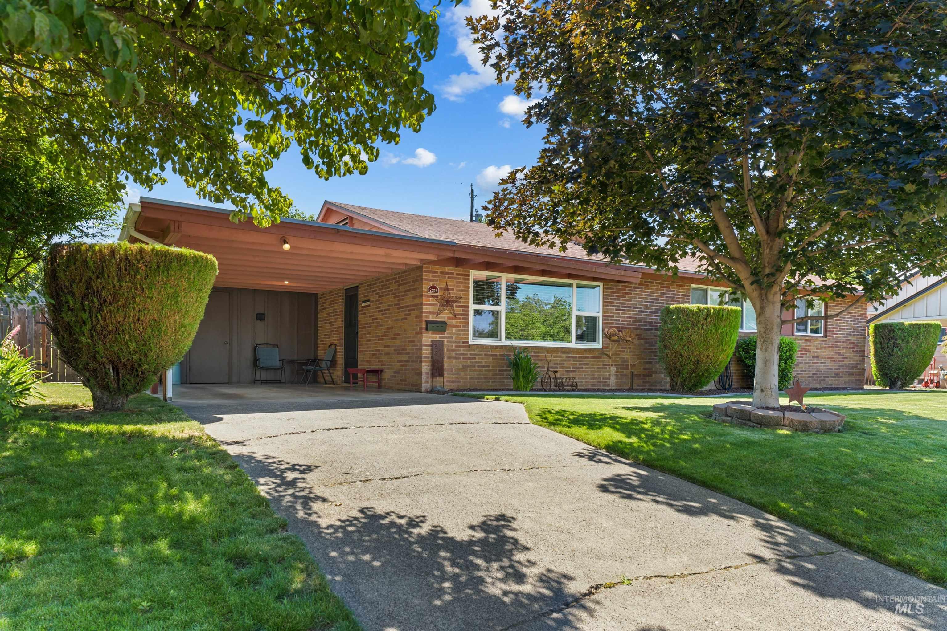 Brick exterior with a covered carport featuring recessed lighting