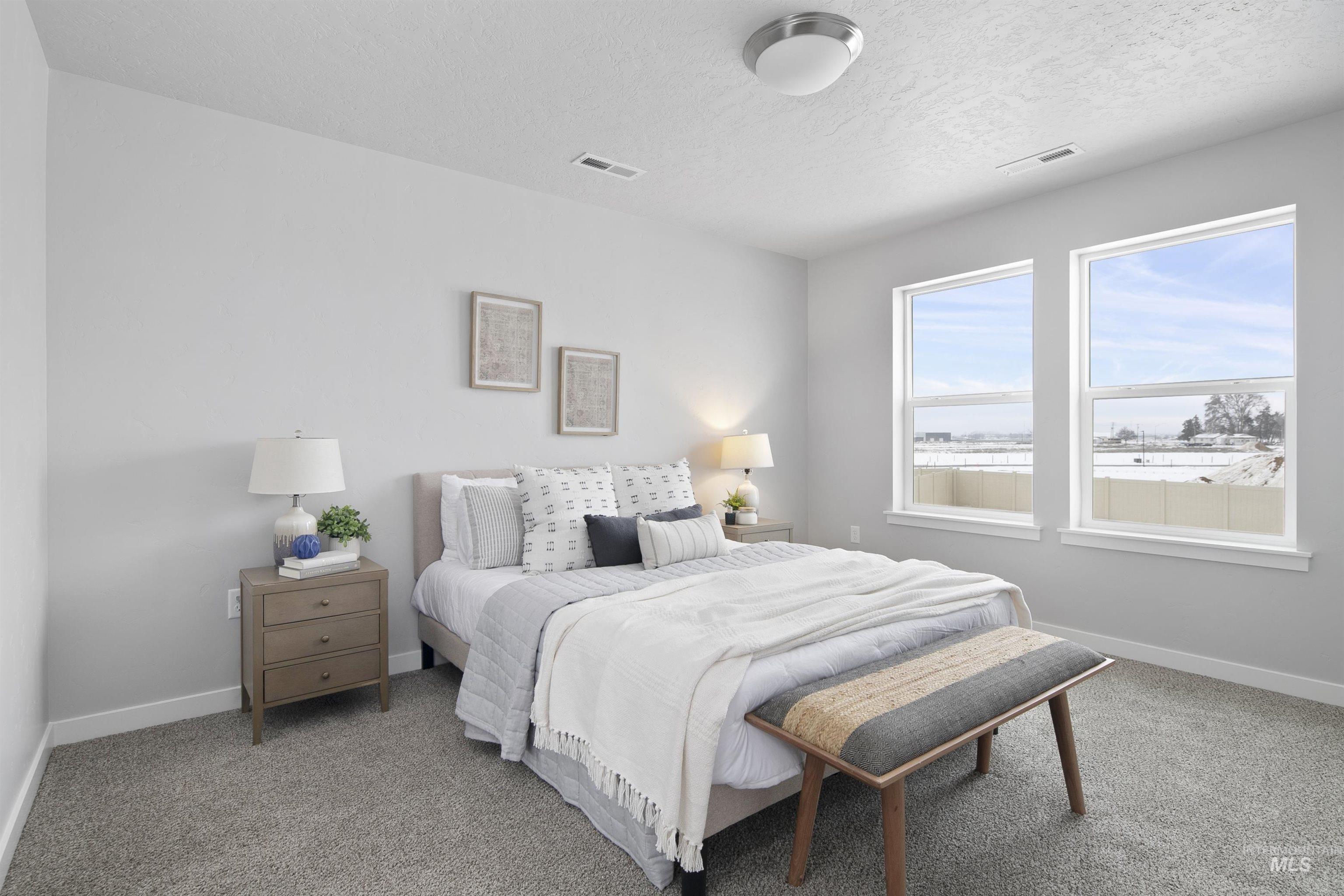 Bedroom with carpet flooring and a textured ceiling