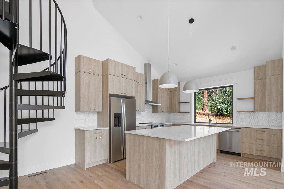 Kitchen featuring open shelves, light brown cabinets, modern cabinets, and high vaulted ceiling
