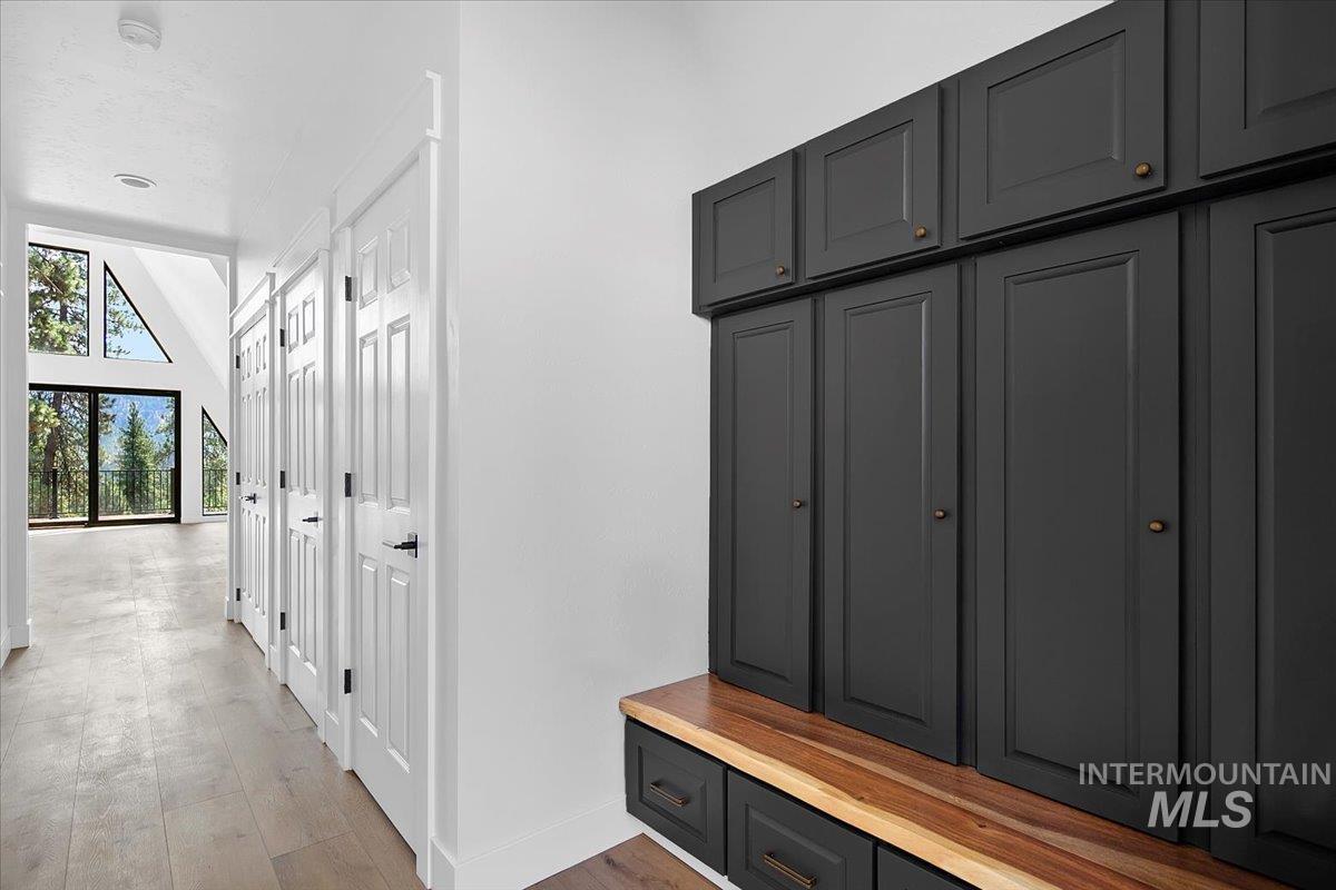 Mudroom featuring light wood-type flooring and baseboards