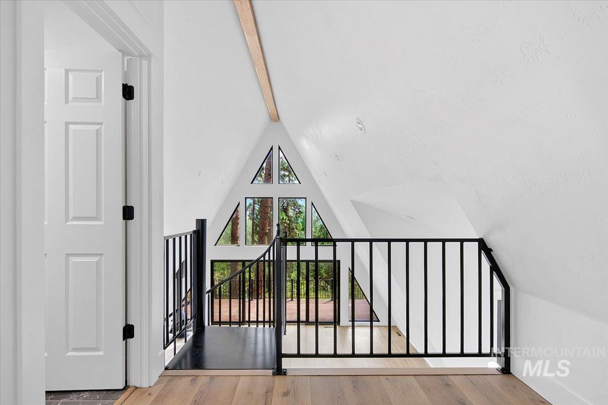 Loft area with wood finished floors