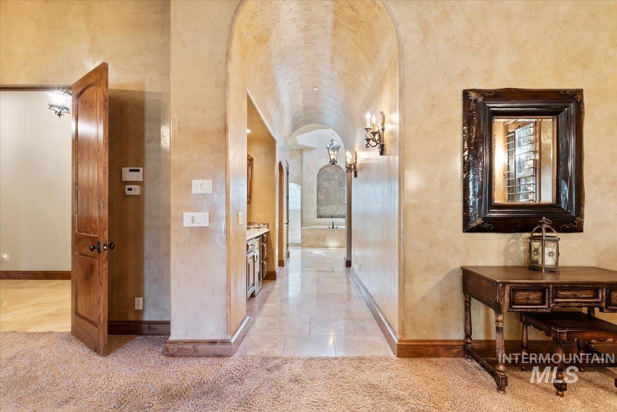 Corridor featuring light carpet