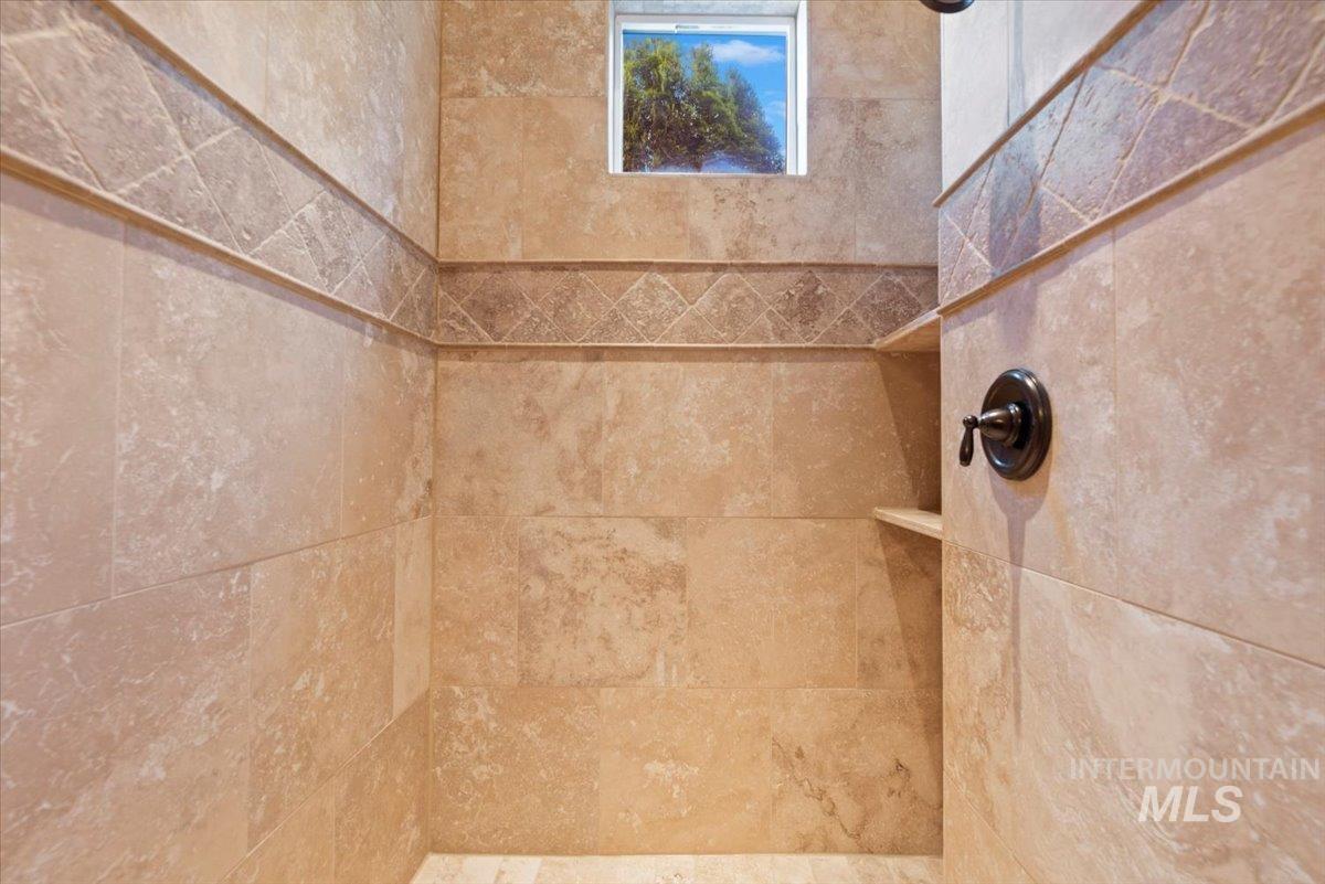 Full bath featuring tiled shower