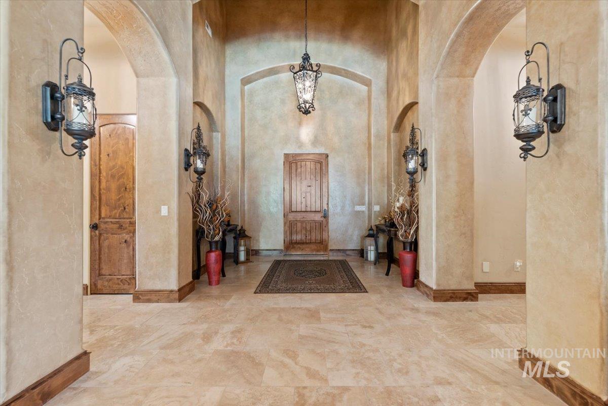 Foyer entrance with arched walkways and a towering ceiling