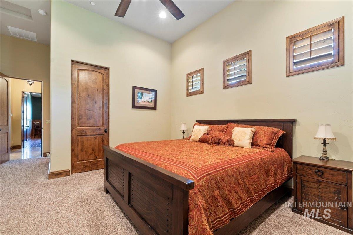Bedroom with light carpet and ceiling fan