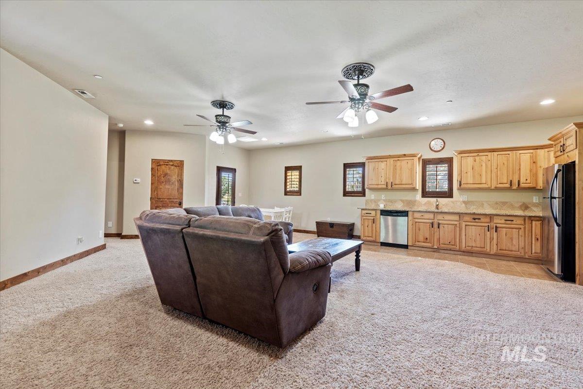 Living area featuring recessed lighting, light carpet, ceiling fan, and healthy amount of natural light