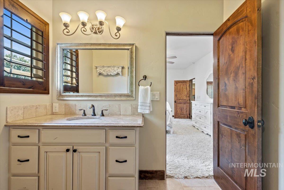 Bathroom featuring vanity, plenty of natural light, and tile patterned floors