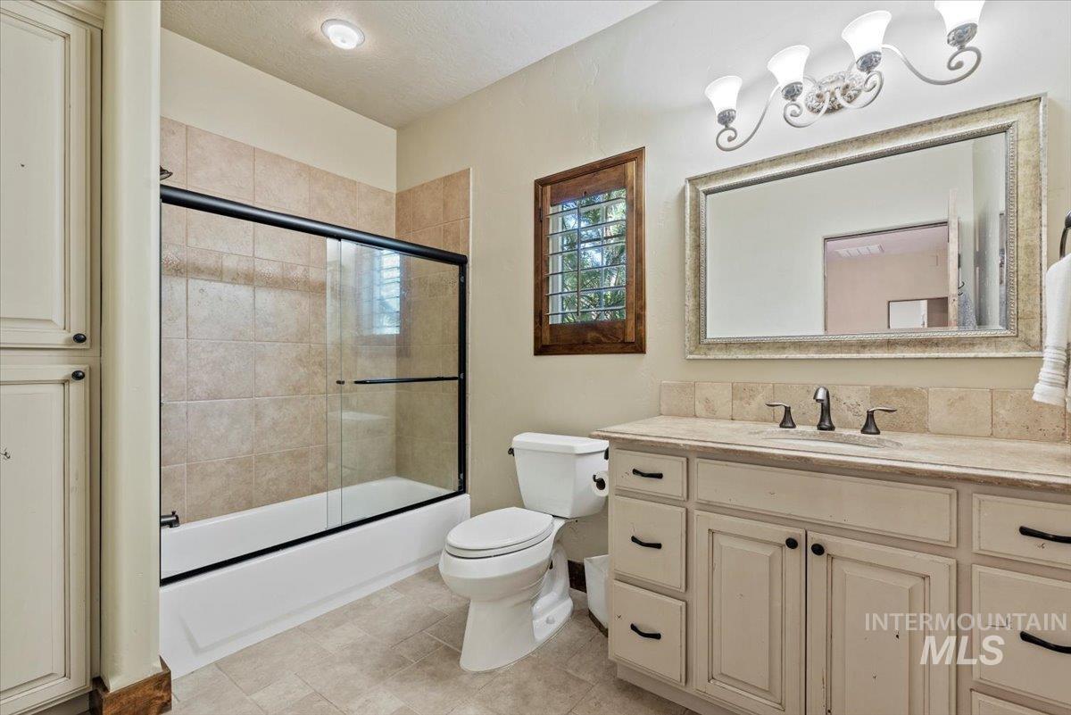Full bathroom with vanity and shower / bath combination with glass door