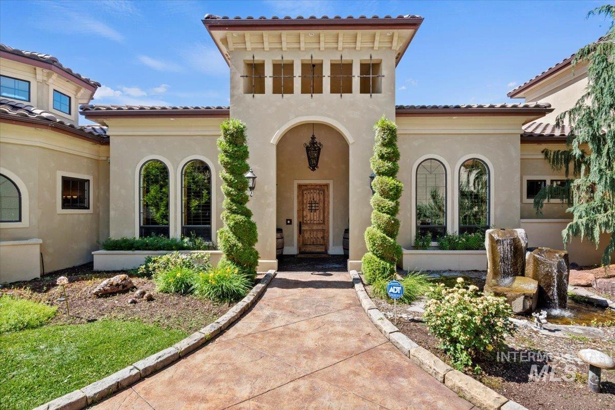 Doorway to property featuring stucco siding and a tile roof