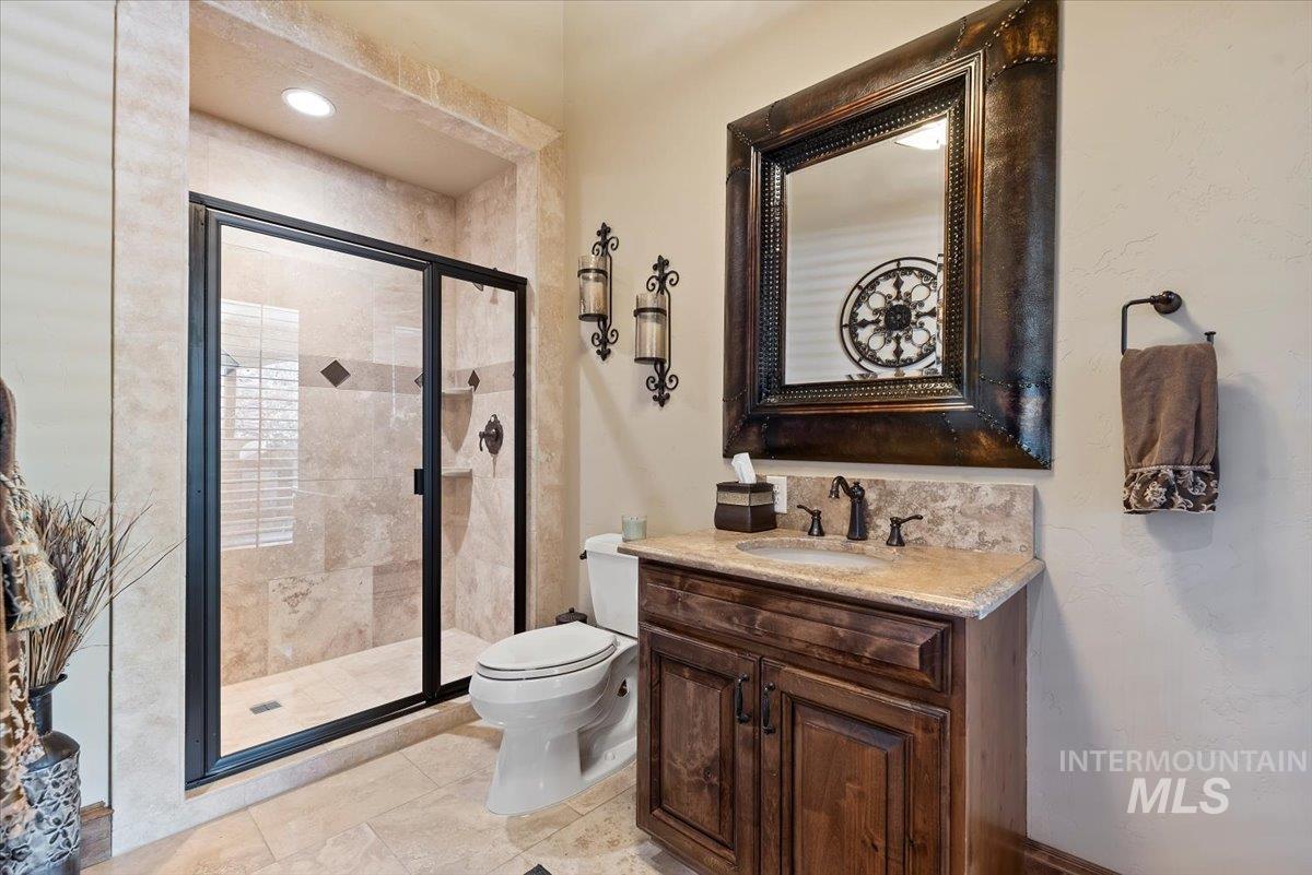 Bathroom with a shower stall and vanity