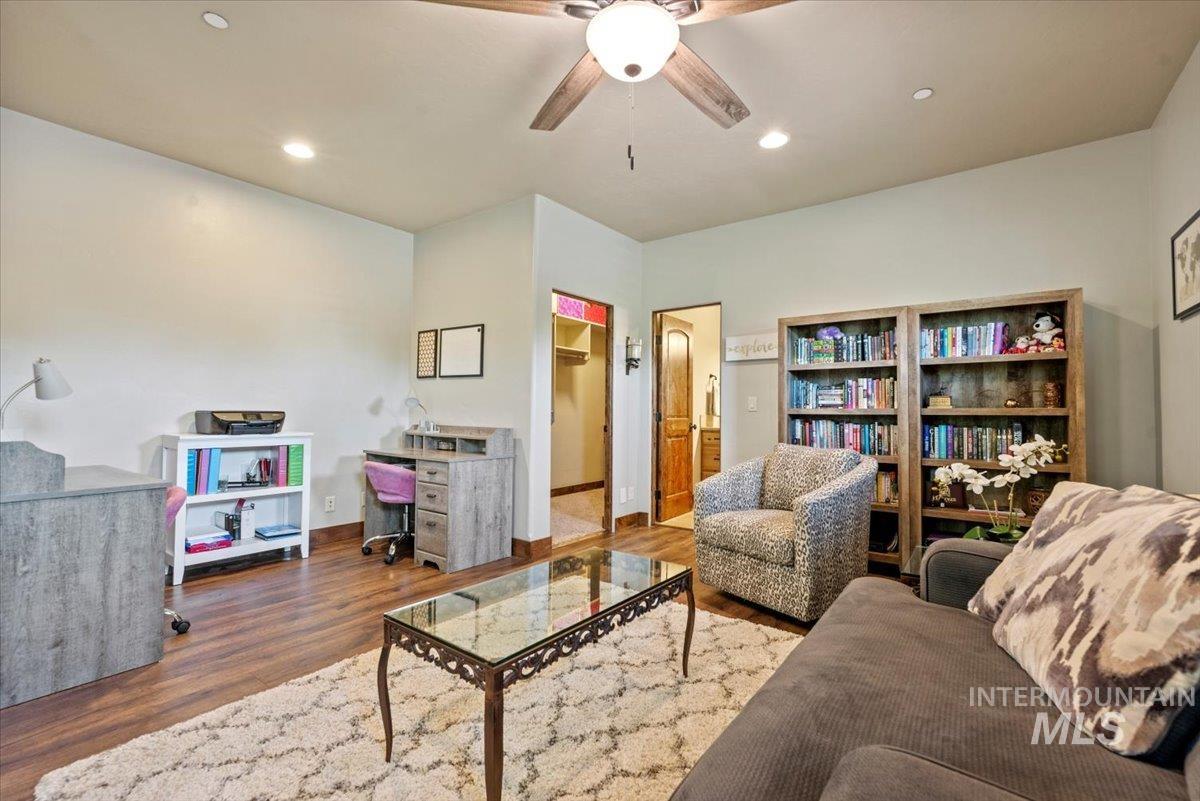 Living room featuring ceiling fan, wood finished floors, and recessed lighting
