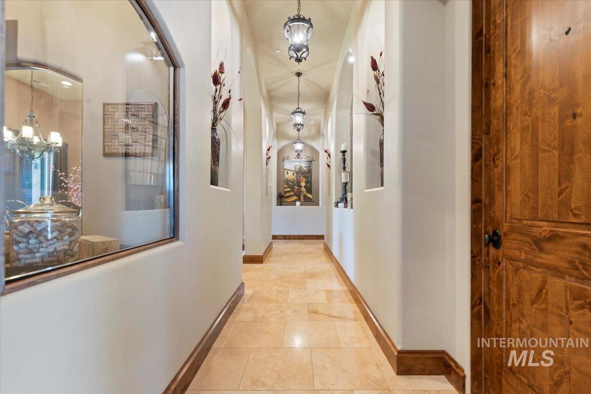 Hall featuring a chandelier and baseboards