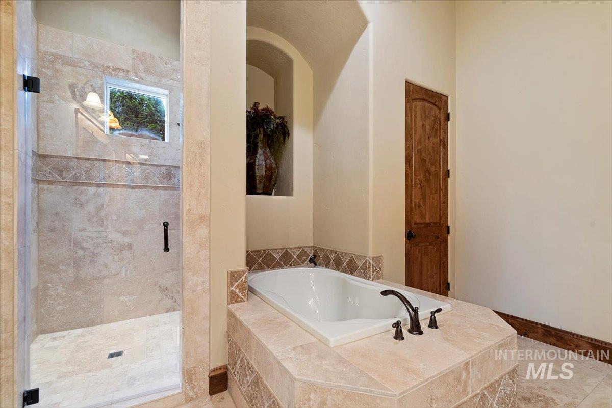 Bathroom with a bath and a stall shower