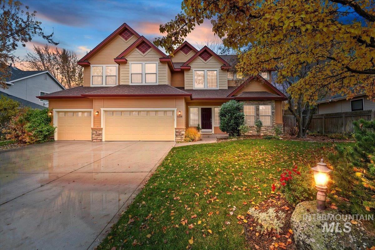 Craftsman inspired home featuring stone siding, concrete driveway, and a garage