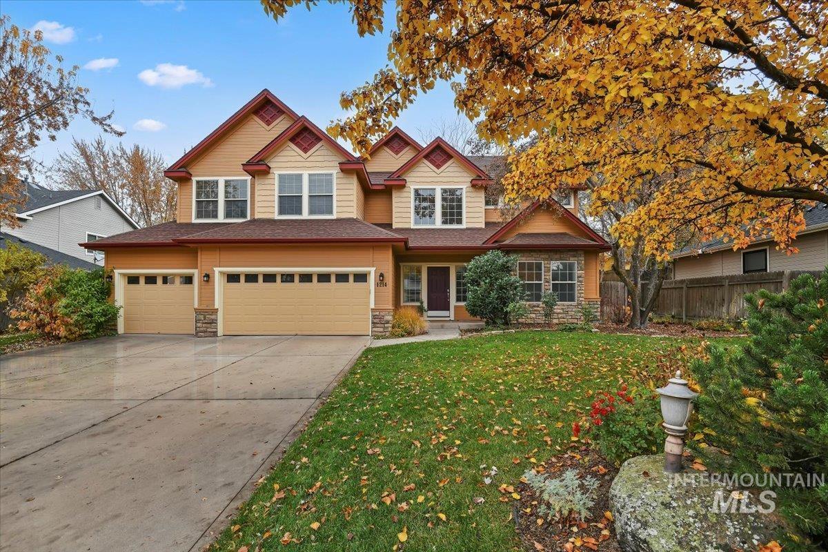 Craftsman-style home with stone siding, concrete driveway, and an attached garage