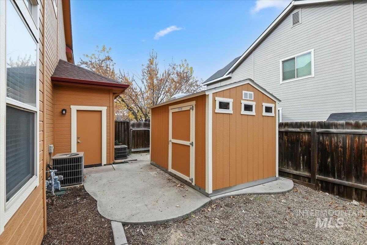 View of shed with a fenced backyard