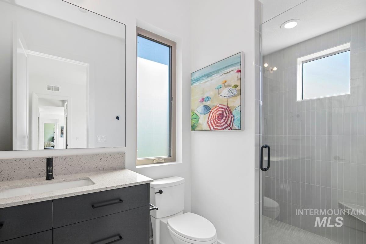 Full bath featuring vanity and a shower stall