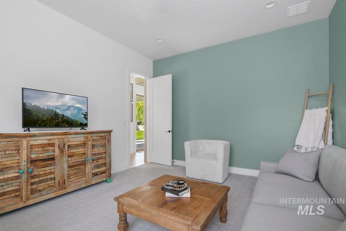 Carpeted living room with baseboards