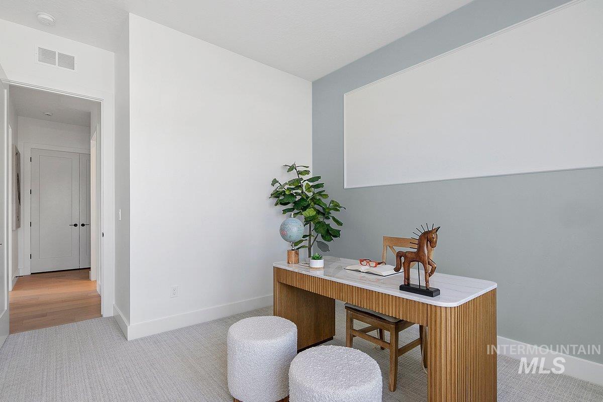 Office featuring light colored carpet and baseboards