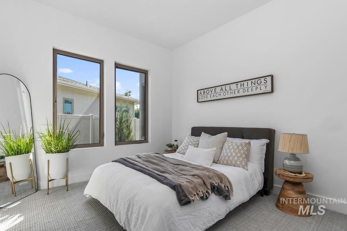 Bedroom with carpet flooring and baseboards