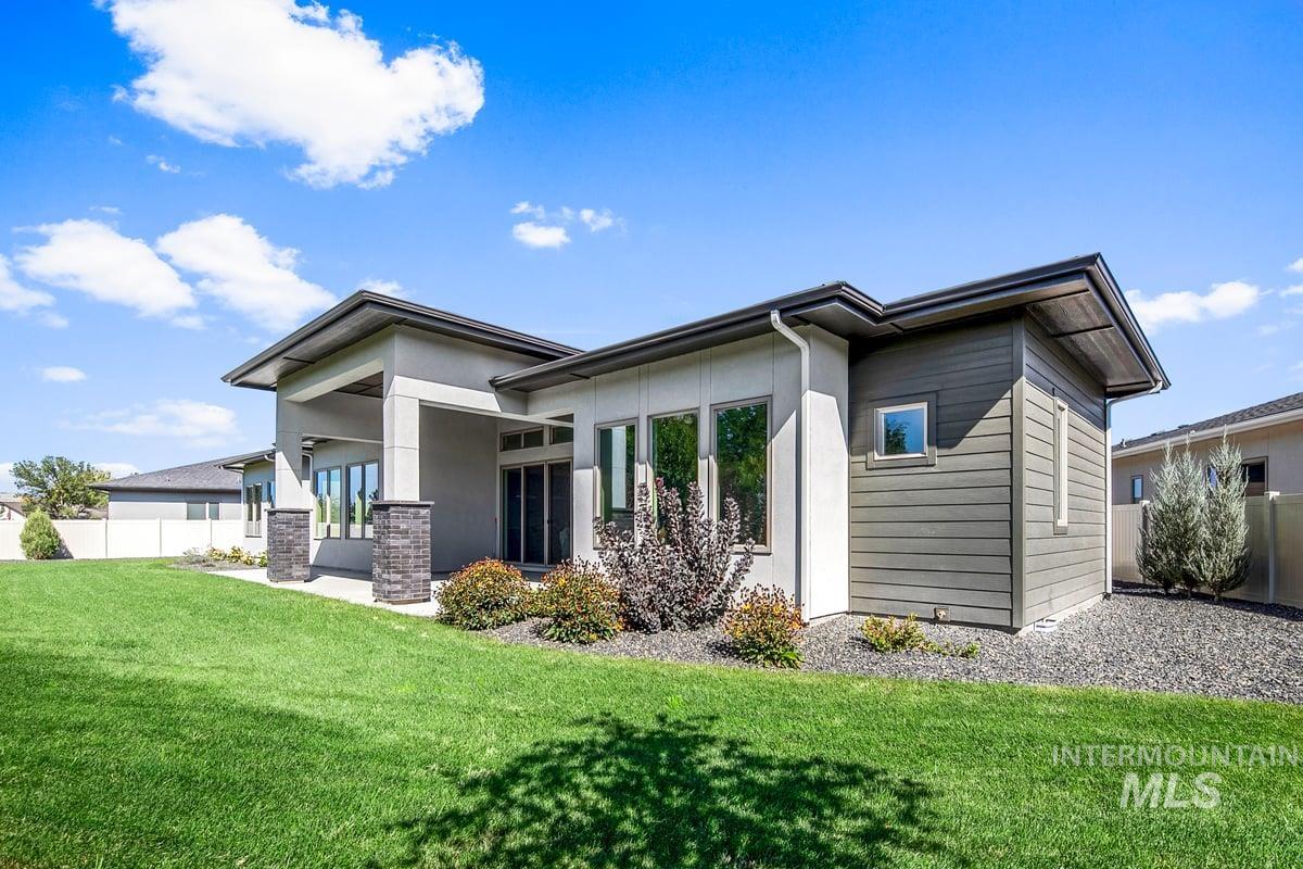 Rear view of property featuring a patio area and stucco siding
