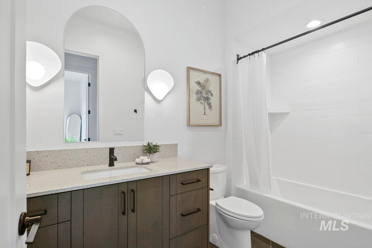 Full bathroom featuring shower / tub combo and vanity