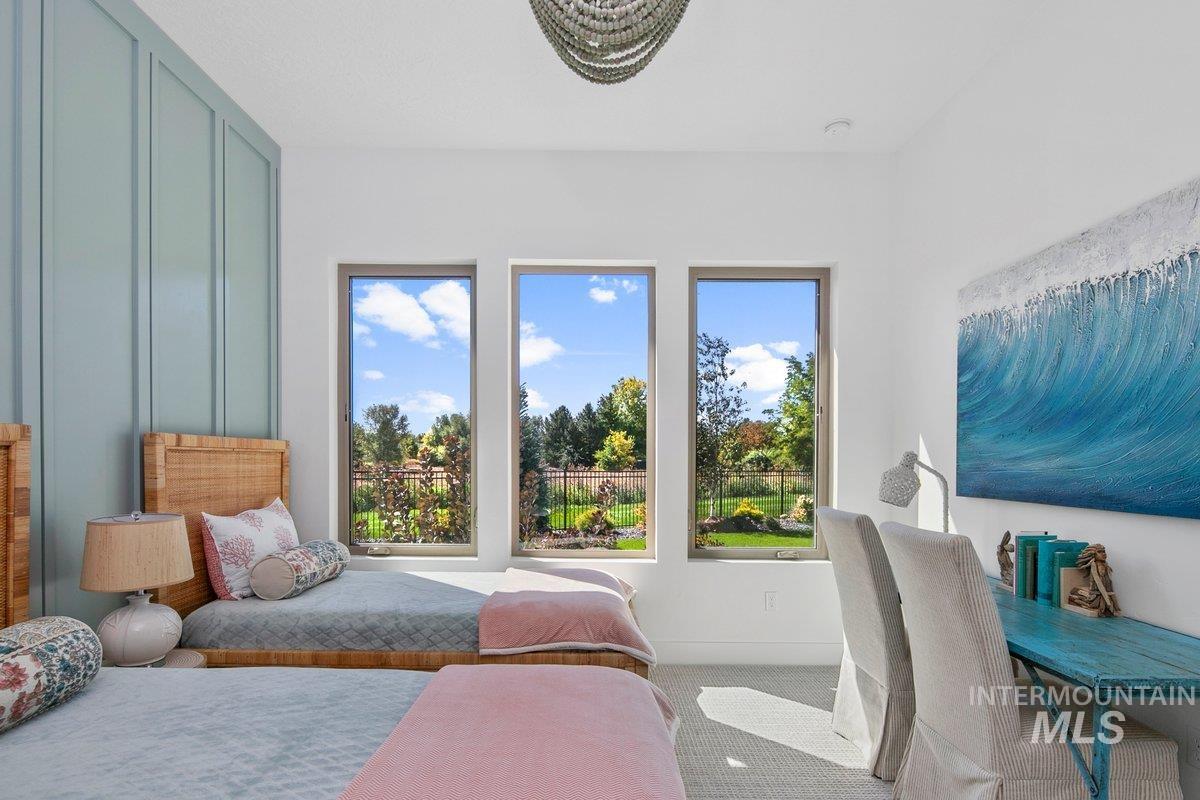 Bedroom featuring carpet floors and baseboards