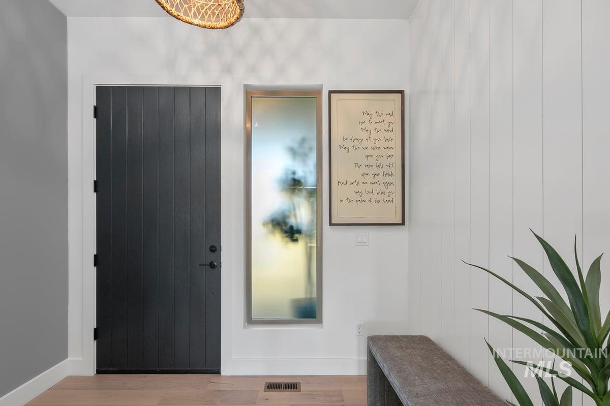 Entrance foyer featuring wood finished floors and baseboards