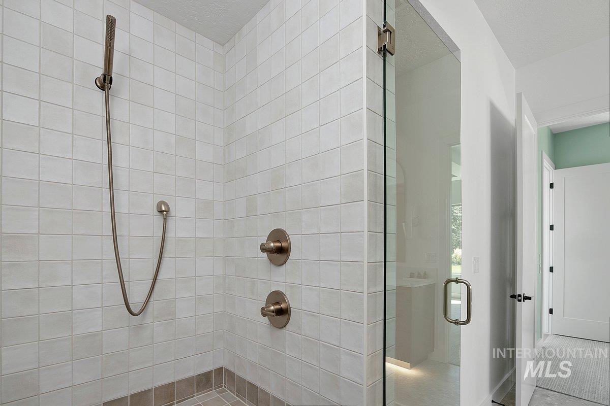 Full bathroom with a stall shower and a textured ceiling