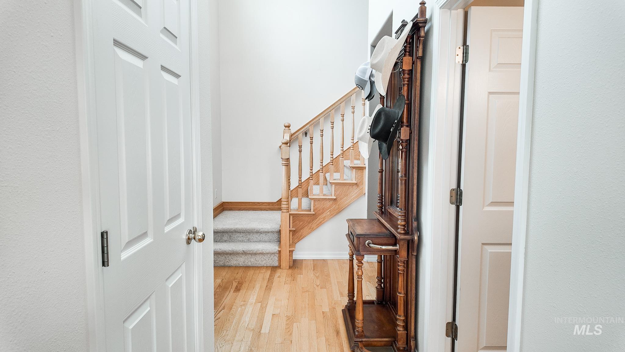 Entrance with Oak Stair Railing, Hardwood Floors and 1/2 Bath.